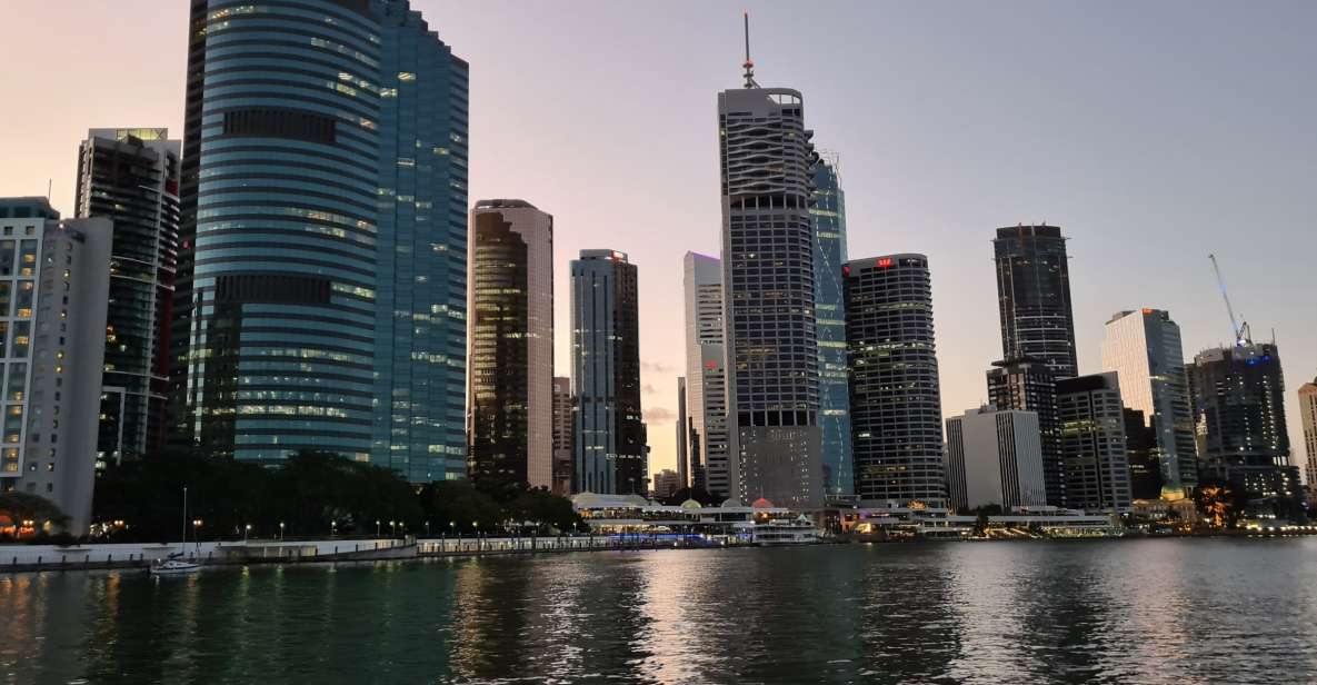 Brisbane: Sunset City Lights Cruise 5.30pm or 6pm <em>seasonal – Drinks and the included charcuterie share board’ /><br />
Let’s talk value, because this part is part of why it works.</p>
<p><p>You get a <strong>complimentary charcuterie share board</strong>, and it arrives during the cruise. It’s not just a token bite; multiple people highlight how good the snack platter is and how it makes the whole evening feel more like a planned treat than a random sightseeing stop.</p>
</p>
<p><p>You can also buy drinks from the <strong>onboard bar</strong>. Drinks are not included, but having the option is a big plus. It means you can keep it light with something non-alcoholic, or go for wine/beer/spirits depending on what’s offered that evening.</p>
</p>
<p><p>Practical note: the tour does <strong>not</strong> allow outside food and drinks. So come hungry for the included board, and plan to purchase anything else you want onboard.</p>
</p>
<p><p>Also worth knowing: onboard <strong>toilets</strong> are available, and people have noted them positively. That small comfort can matter a lot on a night cruise.</p>
</p>
<h2 id="no-guided-commentary-how-to-get-the-most-anyway">No guided commentary: how to get the most anyway</h2>
<p>seasonal – No guided commentary: how to get the most anyway’ /><br />
This cruise is intentionally low-key, and the big heads-up is clear: <strong>there’s no guided commentary</strong>. You won’t get a structured narration about what you’re seeing.</p>
<p><p>If you’re okay with that, the payoff is the calm atmosphere. You can focus on the lighting, the bridges, the reflections, and the feeling of being on the river without a script in your ear.</p>
</p>
<p><p>If you want context, here’s the practical way to handle it: keep your questions in your pocket. Crew members may be able to help point things out when you ask, and they can help you connect the skyline to what you recognize from Brisbane day trips.</p>
</p>
<p><p>One more thing: because there’s no planned narration, timing becomes your guide. Watch the waterfront change as night settles in. That’s the “story” of the cruise.</p>
</p>
<h2 id="rain-delays-and-the-reality-of-sunset">Rain, delays, and the reality of sunset</h2>
<p><img width="900" height="596" decoding="async" src=