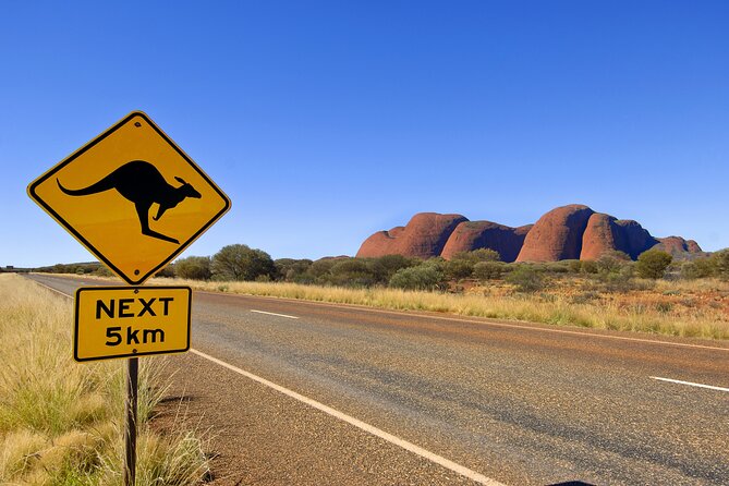 Overnight Uluru Adventure - Camp setup: permanent tents, beds, linen, and shared bathrooms